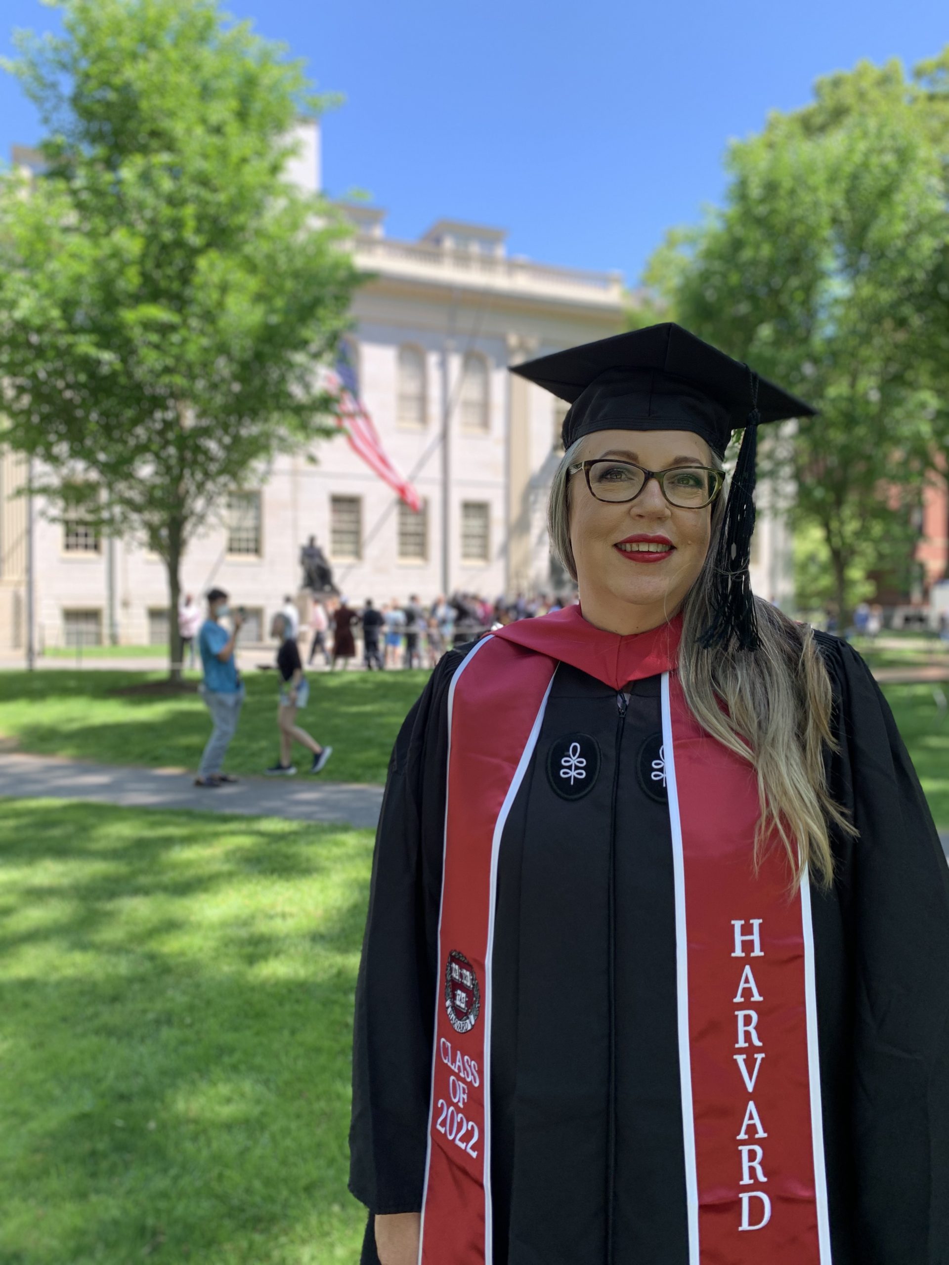 Laurie grad picture with John Harvard statue in the background